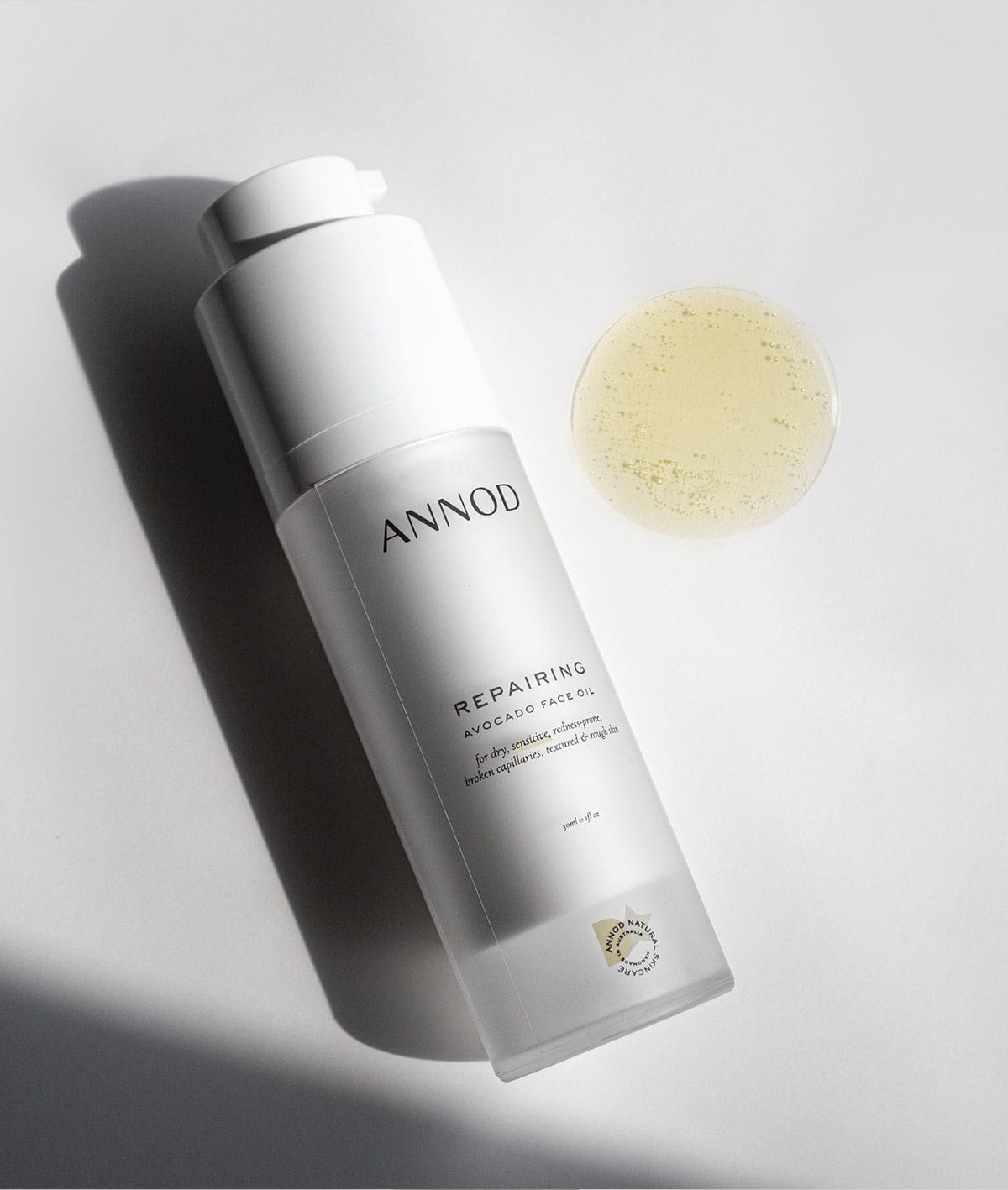 A 30ml bottle Repairing Avocado Face Oil with oil texture